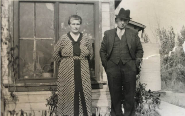 Julianna Balik and Laurance Daku standing outside a frame house, about 1935.