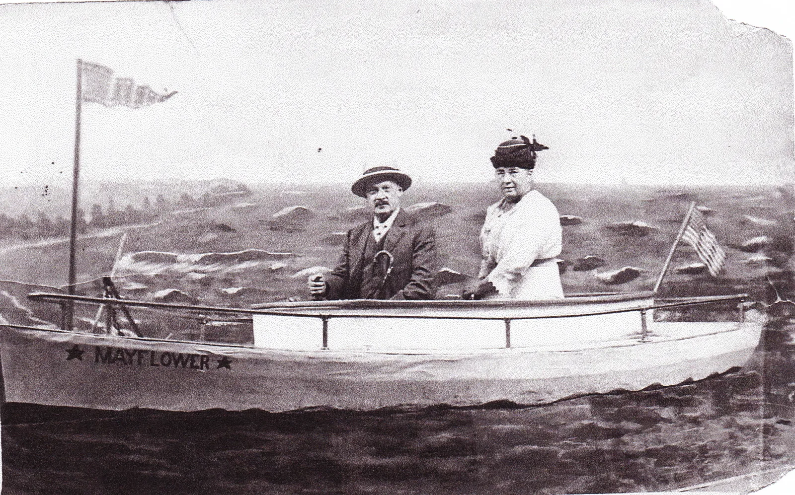 Rudolf and Anna Bernegger seated in a studio rowboat portrait labeled Mayflower