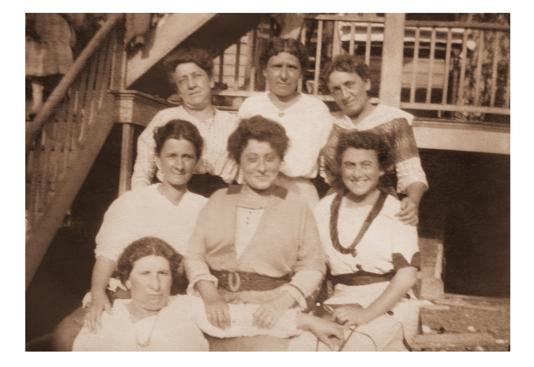 Sadie Tabor standing at back left with a group of women on outdoor steps